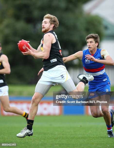 Daniel Nielson of Werribee runs with the ball during the 2017 VFL round 10 match between the Footscray Bulldogs and the Werribee Tigers at Whitten...