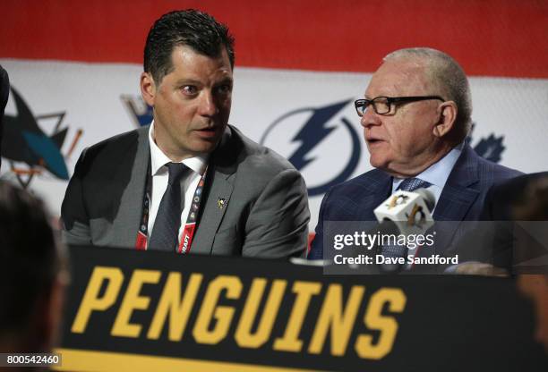 General manager Jim Rutherford, right, and Bill Guerin of the Pittsburgh Penguins talk at the draft table during the 2017 NHL Draft at United Center...