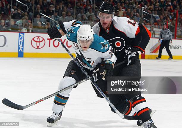 Matt Carle of the San Jose Sharks skates against Jeff Carter of the Philadelphia Flyers on February 21, 2008 at Wachovia Center in Philadelphia,...