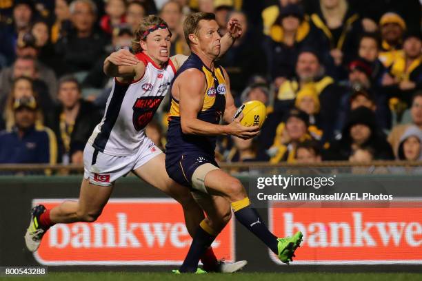 Sam Mitchell of the Eagles tries to evade Jayden Hunt of the Demons during the round 14 AFL match between the West Coast Eagles and the Melbourne...