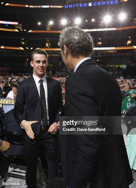 Kole Lind, 33rd overall pick of the Vancouver Canucks, looks to shake the hand of president of hockey operations Trevor Linden of the Vancouver...