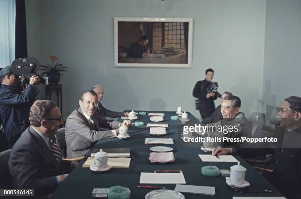 President of the United States, Richard Nixon pictured 2nd from left with National Security Advisor Henry Kissinger as they meet for talks with Zhou...