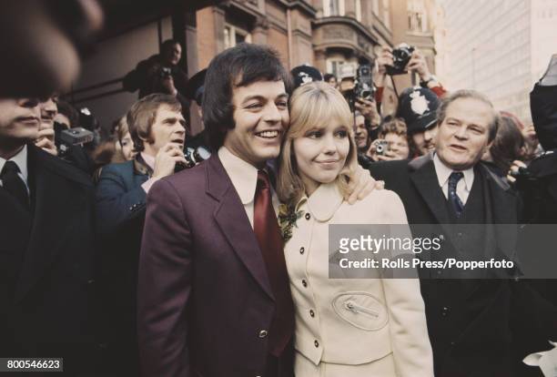 English actress Tessa Wyatt and disc jockey and broadcaster Tony Blackburn stand together in front of reporters, photographers and members of the...
