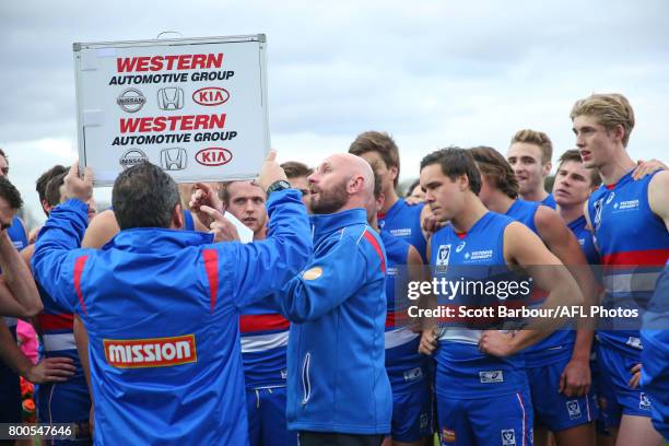 Steve Grace , coach of the Bulldogs speaks to his team during a quarter time break during the 2017 VFL round 10 match between the Footscray Bulldogs...