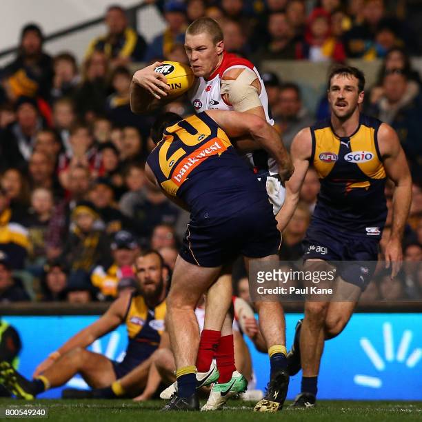 Tom McDonald of the Demons looks to break from a tackle by Jeremy McGovern of the Eagles during the round 14 AFL match between the West Coast Eagles...
