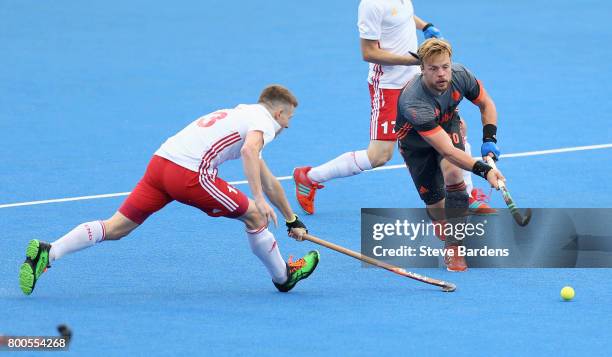 Mink van der Weerden of the Netherlands passes under pressure from Sam Ward of England during the semi-final match between England and the...