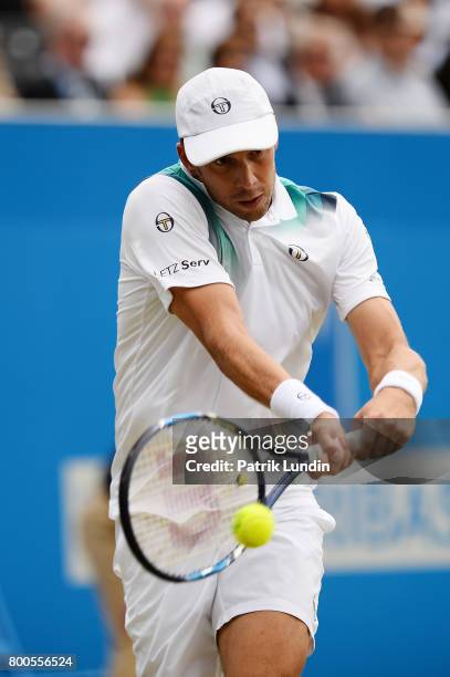 Gilles Muller of Luxemburg hits a backhand during the Semi Final match against Marin Cilic of Croatia on day six at Queens Club on June 24, 2017 in...