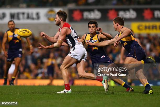 Tomas Bugg of the Demons handballs during the round 14 AFL match between the West Coast Eagles and the Melbourne Demons at Domain Stadium on June 24,...