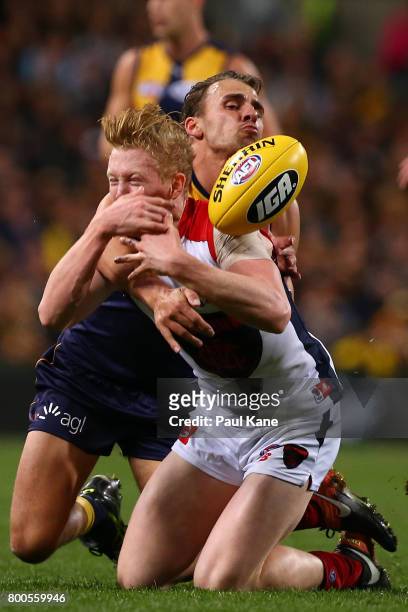 Dom Sheed of the Eagles tackles Clayton Oliver of the Demons during the round 14 AFL match between the West Coast Eagles and the Melbourne Demons at...