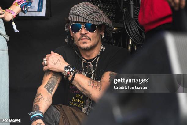 Johnny Depp sits at the side of the Pyramid Stage watching 'Run The Jewels' perform on day 3 of the Glastonbury Festival 2017 at Worthy Farm, Pilton...