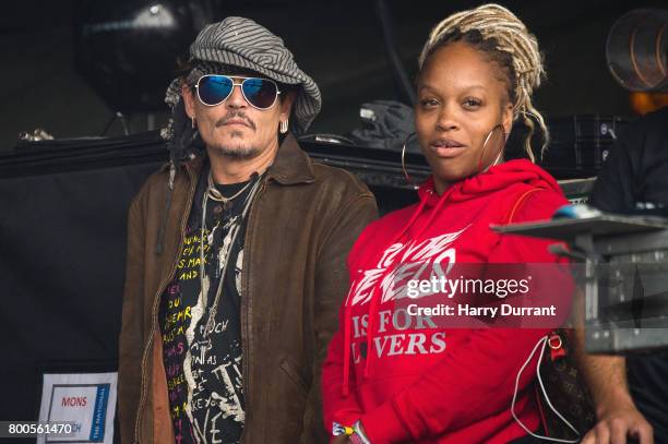 Johnny Depp sits at the side of the Pyramid Stage watching 'Run The Jewels' perform on day 3 of the Glastonbury Festival 2017 at Worthy Farm, Pilton...