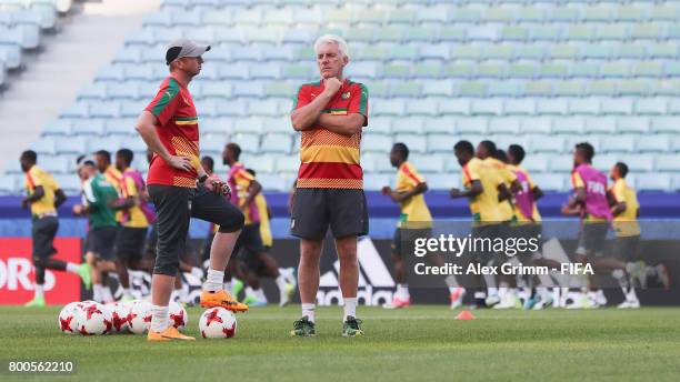 Head coach Hugo Broos and assistant coach Sven Vandenbroeck look on during a Cameroon training session at Fisht Olympic Stadium ahead of their FIFA...