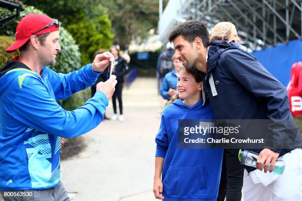 Novak Djokovic of Serbia poses for a photo with a fan during Qualifying on Day 2 of The Aegon International Eastbourne on June 22, 2017 in...