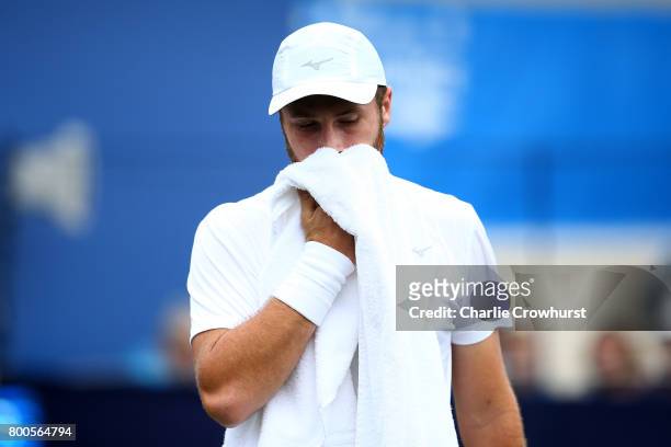 Luke Bambridge of Great Britain wipes his face during his qualifying match against Marek Jaloviec of Czech Republic during Qualifying on Day 2 of The...