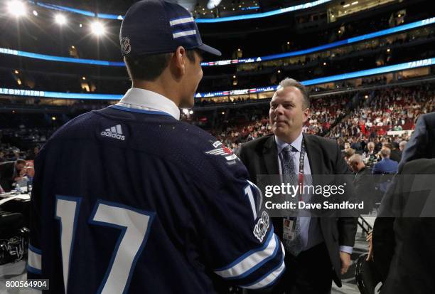 Johnny Kovacevic meets general manager Kevin Cheveldayoff after being selected 74th overall by the Winnipeg Jets during the 2017 NHL Draft at United...