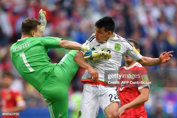 Russia's goalkeeper Igor Akinfeev jumps to block Mexico's forward Hirving Lozano as he scores the second goal during the 2017 Confederations Cup...