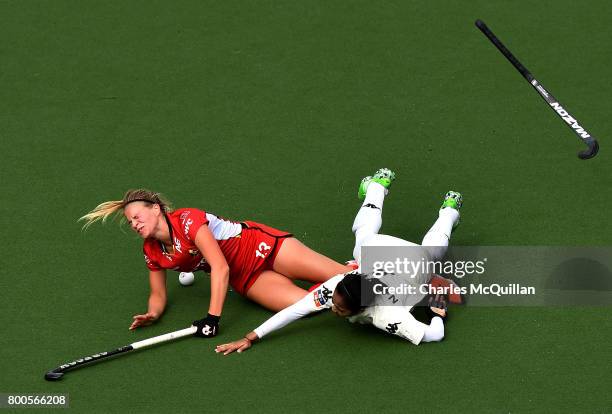 Alix Gerniers of Belgium is fouled by Nurul Mansur of Malaysia during the FINTRO Women's Hockey World League Semi-Final Pool B game between Belgium...