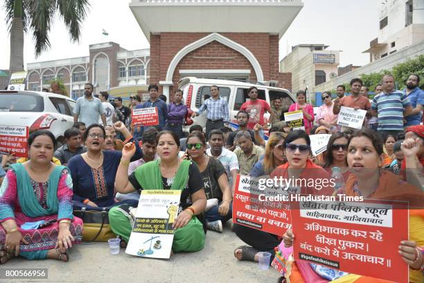 Parents and association members staged protest outside Khaitan Public School after the institution expelled 35 students for not depositing the...