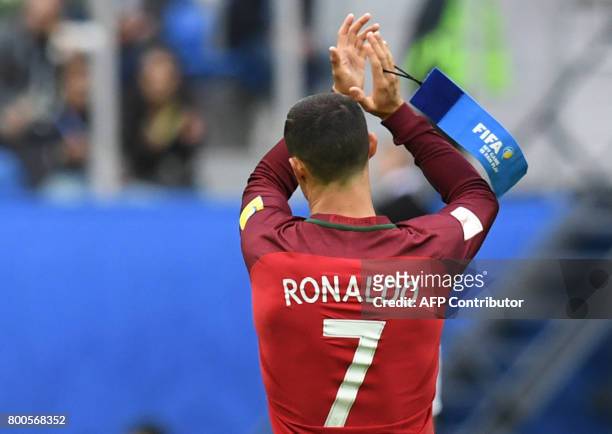 Portugal's forward Cristiano Ronaldo holds his captain armband as he leaves the pitch after being substituted during the 2017 Confederations Cup...
