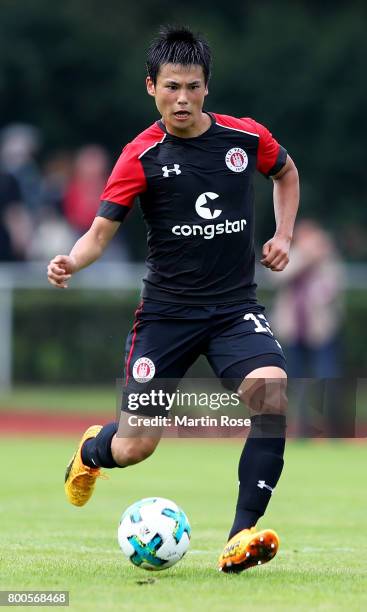 Ryo Miyaichi of St. Pauli runs with the ball during the preseason friendly match between Buxtehuder SV and FC St. Pauli at on June 24, 2017 in...