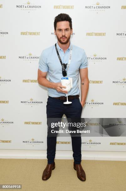 Tom Riley celebrates with Moet Ice Imperial in the Moet & Chandon Suite, whilst watching the action unfold on Centre Court, at the Aegon...