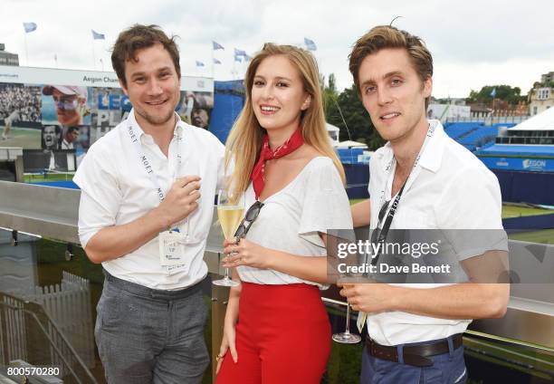 Henry Pettigrew, Hanako Footman and Jack Farthing celebrate with Moet Ice Imperial in the Moet & Chandon Suite, whilst watching the action unfold on...