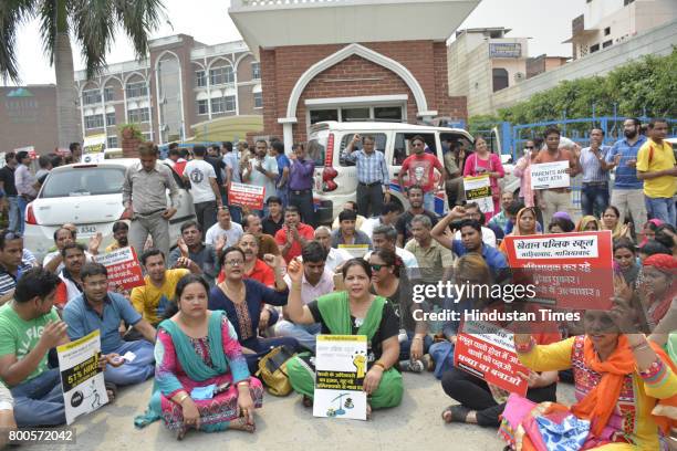 Parents and association members staged protest outside Khaitan Public School after the institution expelled 35 students for not depositing the...