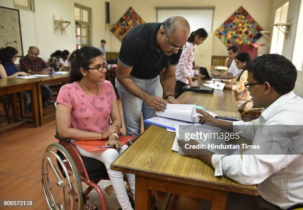 Physically challenged student and her parents being guided by volunteer during an admission process for the new Academic Year 2017-18, at Lady Shri...