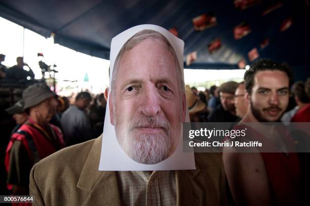 Man wears a Jeremy Corbyn mask whilst waiting for the Labour Party leader to speak to crowds at Left Field Stage at Glastonbury Festival Site on June...