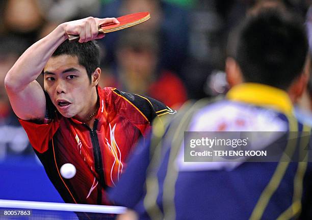 Taiwan's Chuan Chihyuan returns a shot against Japan's Kaii Yoshida during their men's quarter-final and position match at the World Team Table...