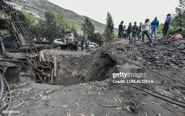 Relatives of missing miners wait during search operations after an explosion at the El Cerezo illegal coal mine killed at least eight people, in the...