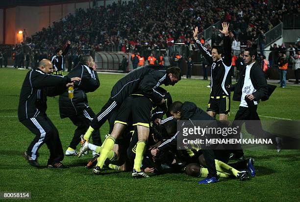 Beitar Jerusalem players celebrate after beating Israeli Arab Bnei Sakhnin during their national football cup match in the northern Israeli Arab town...