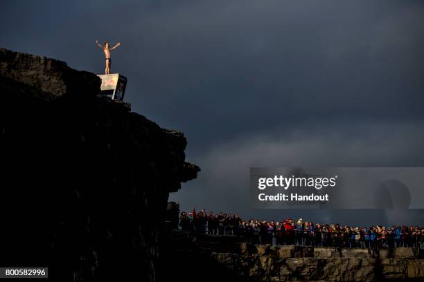 In this handout image provided by Red Bull, Gary Hunt of the UK acknowledges the spectators prior to diving from the 27.5 metre platform at the...