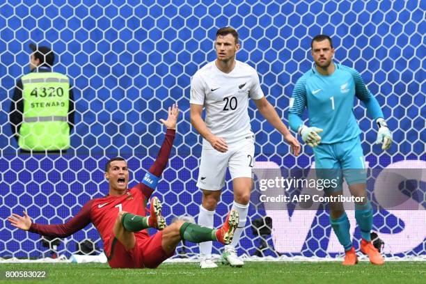 Portugal's forward Cristiano Ronaldo reacts next to New Zealand's defender Tommy Smith and New Zealand's goalkeeper Stefan Marinovic after missing a...