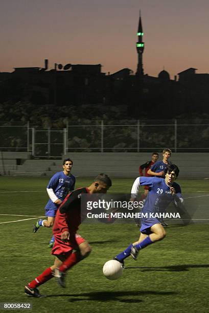 Players of Bnei Sakhnin under-18 team play football during a training session in their home football stadium in the northern Israeli Arab town of...