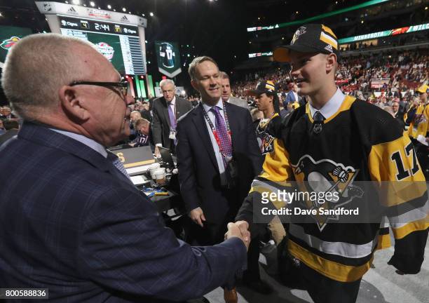 Clayton Phillips meets general manager Jim Rutherford after being selected 93rd overall by the Pittsburgh Penguins during the 2017 NHL Draft at...