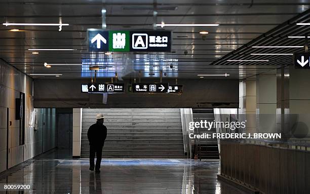 Man walks in an empty subway station on February 29, 2008 in Beijing, during a media preview of new subway lines being built and to be completed...