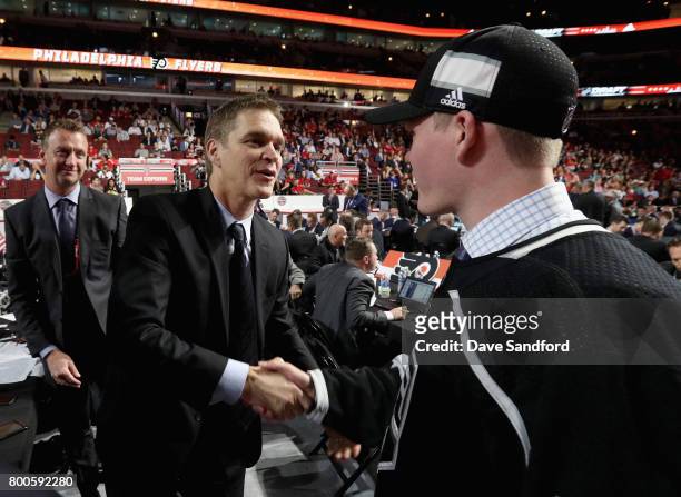 Mikey Anderson meets Luc Robitaille after being selected 103rd overall by the Los Angeles Kings during the 2017 NHL Draft at United Center on June...