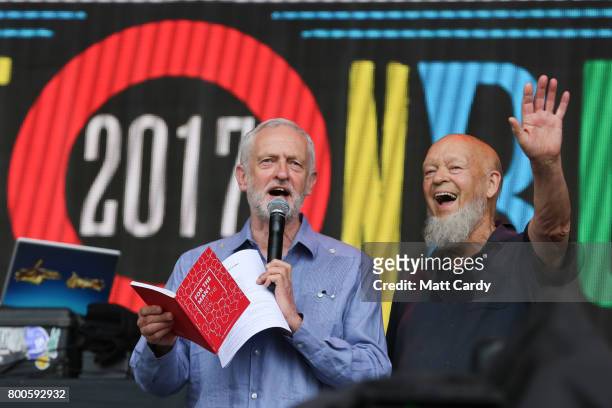 Labour Party leader Jeremy Corbyn and festival founder Michael Eavis address the crowd from the main stage at the Glastonbury Festival site at Worthy...