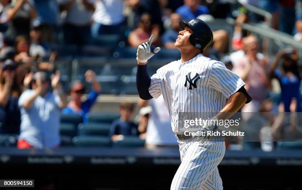 Aaron Judge of the New York Yankees gestures after he hit a home run against the Texas Rangers during the sixth inning of a game at Yankee Stadium on...