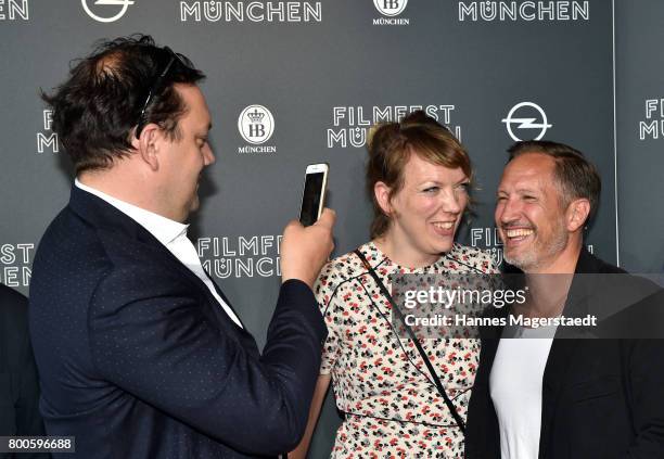 Actor Charly Huebner tkes a picture of Lina Beckmann and Benno Fuermann during the 'Fuehlen Sie sich manchmal ausgebrannt und leer?' Premiere during...