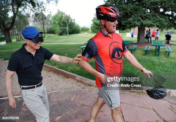 Brian Curran with Eyecycle, right, guides blind participant Peter Chan to a tandem bicycle at the Colorado Center For the Blind June 24, 2017 in...