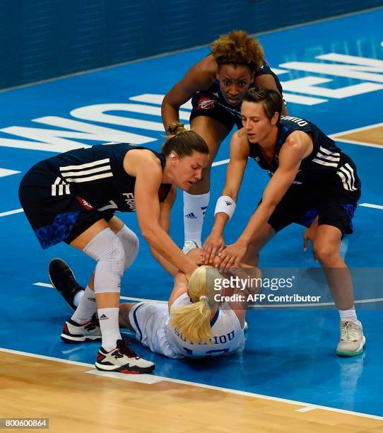 Gaelle Skrela Celine Dumerc and Diandra Tchatchouang of France vie for a ball with Aikaterina Sotiriou of Greece during the FIBA EuroBasket 2017...