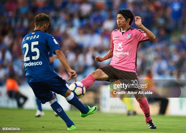 Sergio Mora of Getafe CF competes for the ball with Gaku Shibasaki of CD Tenerife during La Liga 2 play off round between Getafe and CD Tenerife at...