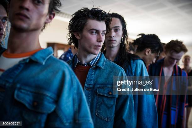 Model prepares backstage before the White Mountaineering Menswear Spring/Summer 2018 show as part of Paris Fashion Week on June 24, 2017 in Paris,...