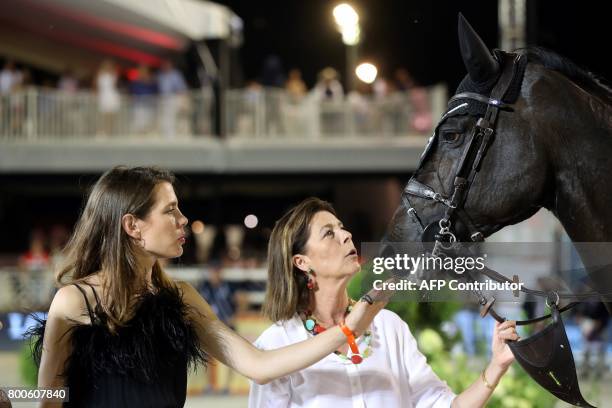 Charlotte Casiraghi and princess Caroline of Hanover look at a horse during a ceremony as part of the 2017 edition of the Jumping International of...