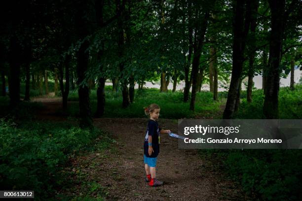 Girl who competed in the Iron Kids race has fun in the middle of the forest the day before of Ironman 70.3 UK Exmoor at Wimbleball Lake on June 24,...