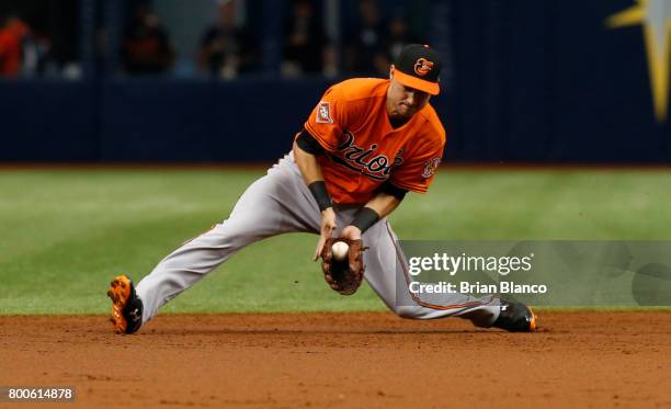 Shortstop Paul Janish of the Baltimore Orioles starts out the double play grounder by Daniel Robertson of the Tampa Bay Rays during the third inning...