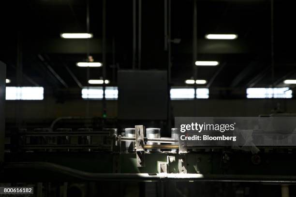 Cans of peas and carrots move along a conveyor belt as they enter a labeling machine at the Del Monte Foods Inc. Facility in Mendota, Illinois, U.S.,...