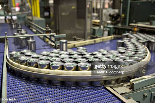 Cans of peas and carrots move along a conveyor at the Del Monte Foods Inc. Facility in Mendota, Illinois, U.S., on Friday, June 23, 2017. The...